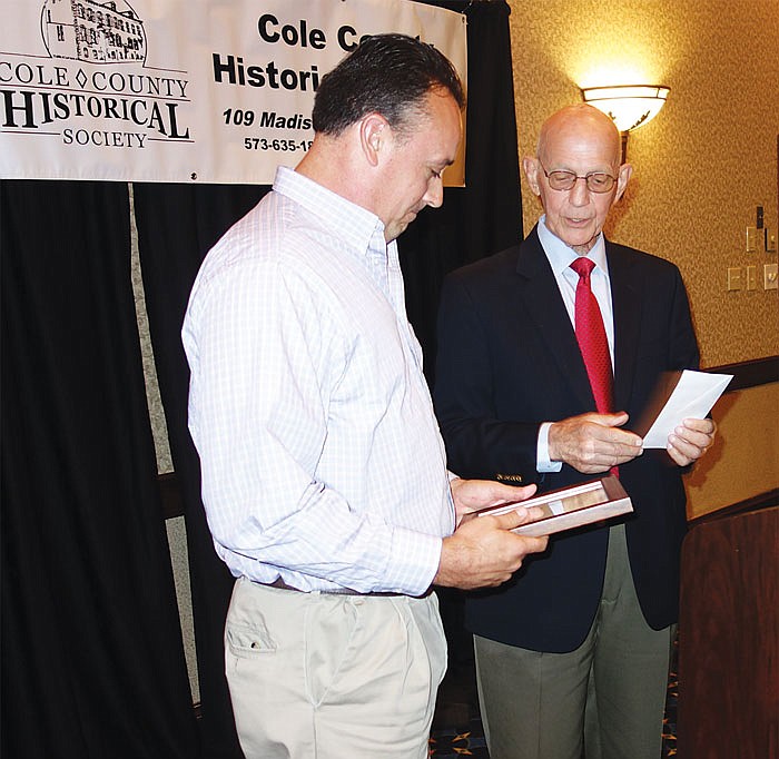 Jeremy Amick received the Cole County Historical Society's 2016 Hope Award from Jim Weber, CCHS president.