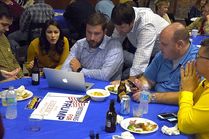 Members of U.S. Rep. Blaine Luetkemeyer's staff constantly refresh their web browsers to see how the Republican Party is doing in the national election at the Republican watch party Tuesday, Nov. 8, 2016 at the Millbottom in Jefferson City.