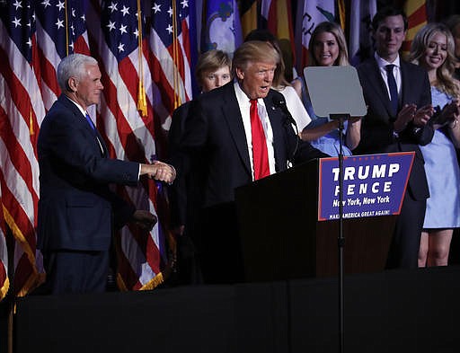 President-elect Donald Trump holds Vice-President-elect Mike Pence's hand as he gives his acceptance speech during his election night rally, Wednesday, Nov. 9, 2016, in New York.