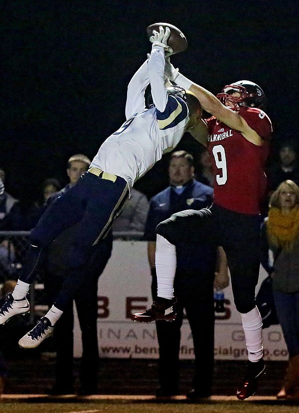 Grant Bryan of Helias goes up for an interception during Friday night's game against Hannibal at Hannibal.