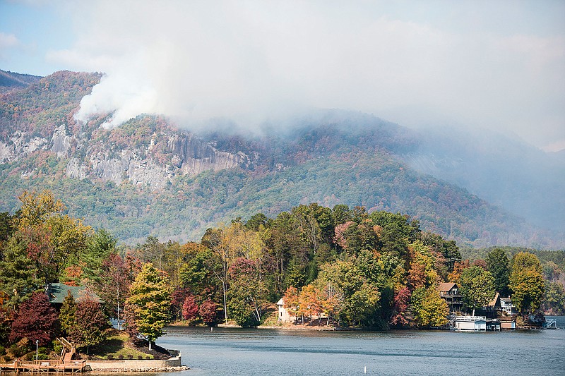 Smoke from the Party Rock fire near Lake Lure spreads as emergency services and the N.C. Forest Service work to contain the blaze Wednesday Nov. 9, 2016 at Lake Lure, N.C.  Unseasonably warm dry weather has deepened a drought that's igniting forest fires across the southeastern U.S.   