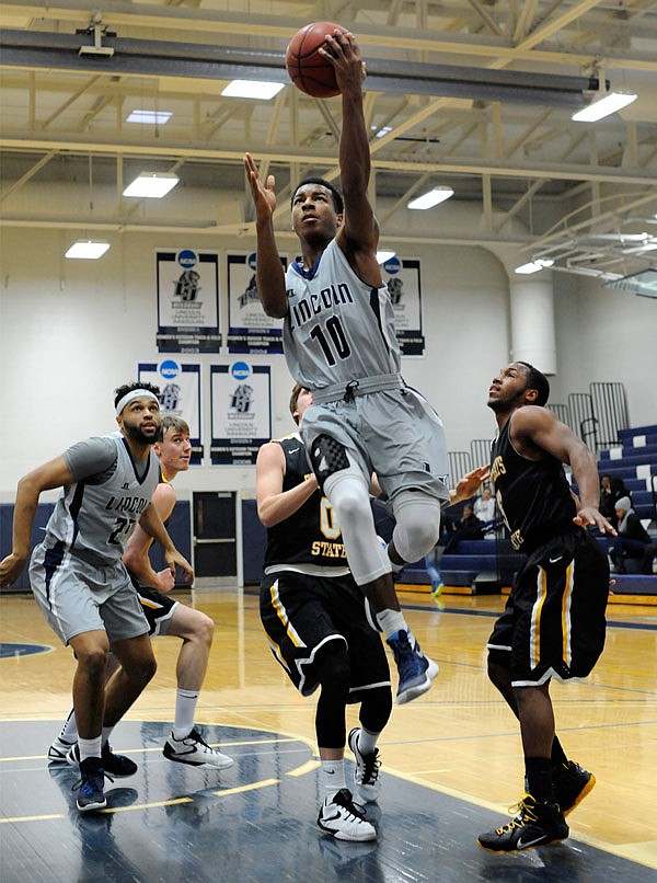 Lincoln guard Jaylon Smith splits the Fort Hays State defense and drives the lane for a layup during a game last season at Jason Gym.