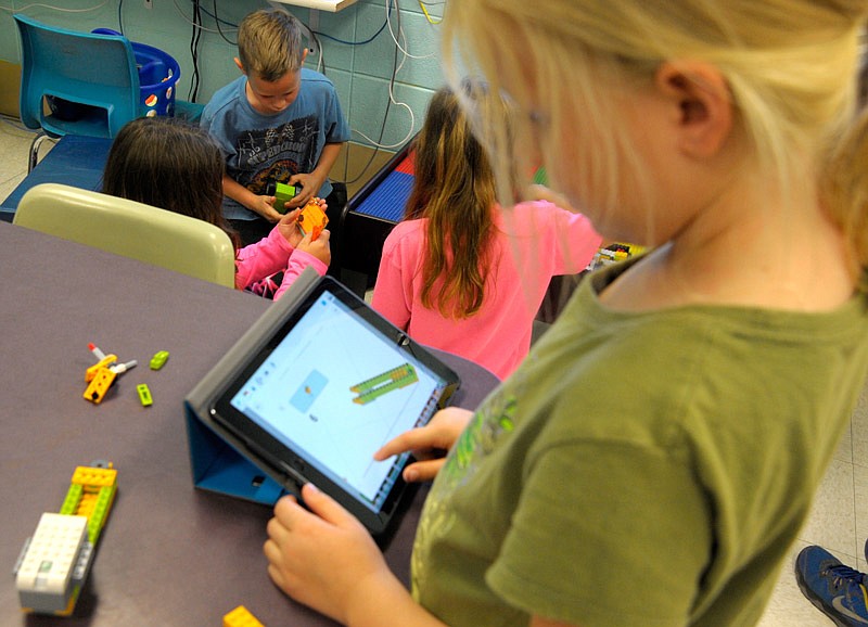 Second graders in Tracey Bieri's Russellville Elementary School class benefit from STEM-related activities, like Emma Gardner who is building a LEGO robot.