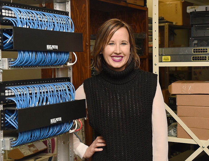 IT manager Amber Addison poses next to a server rack in the Truman State Office Building in Jefferson City. 