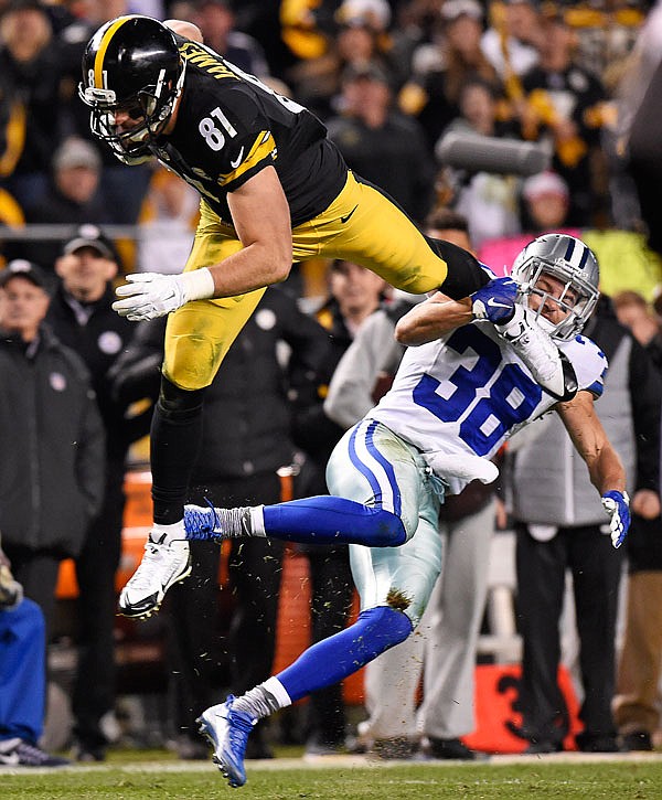 Steelers tight end Jesse James is upended as he attempts to leap over Cowboys strong safety Jeff Heath during the second half of Sunday's game in Pittsburgh.