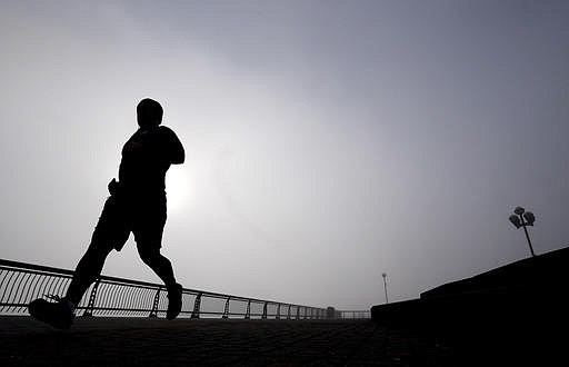 In this Wednesday, Jan. 15, 2014 file photo, a man jogs at Pier A Park in Hoboken, N.J.