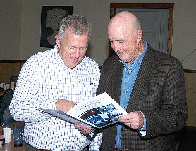 After the MRED meeting in Tipton on Nov. 9, the proposed marketing materials are checked out by Mike Kelley, left, chair of the MRED Board, and Cliff Callis, of Callis & Associates, Sedalia.