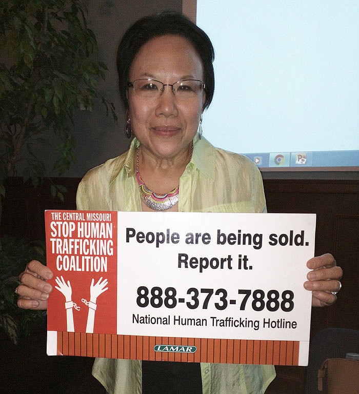 Nanette Ward, a founding member of the Central Missouri Stop Human Trafficking Coalition, displays the toll-free number of the National Human Trafficking Hotline.