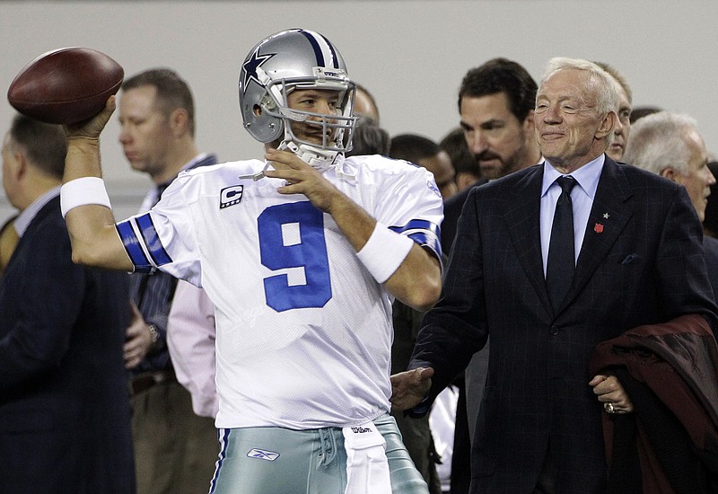 In this Sunday, Dec. 11, 2011 file photo, Dallas Cowboys owner Jerry Jones, right, watches as quarterback Tony Romo throws the ball before an NFL football game against the New York Giants in Arlington, Texas. Dallas Cowboys owner and general manager Jerry Jones anticipates Tony Romo being on the roster next year even though the 36-year-old quarterback has lost the starting job for now to rookie Dak Prescott, Thursday, Nov. 17, 2016. 