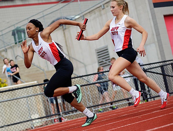 Jacquelyn Walker (right) hands the baton to Jefferson City teammate Niya Slaughter during the 4x100-meter relay in the Capital City Invitational earlier this year at Adkins Stadium.