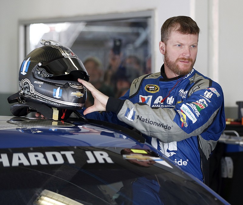 In this Feb. 18, 2016, file photo, Dale Earnhardt Jr prepares to climb into his car to practice for NASCAR's Daytona 500 Sprint Cup series auto race at Daytona International Speedway in Daytona Beach, Fla. Dale Earnhardt Jr. should be medically cleared from his concussion in December and ready to race in the 2017 Daytona 500. Team owner Rick Hendrick said Earnhardt recently sent a text that said he was just waiting for Daytona. 