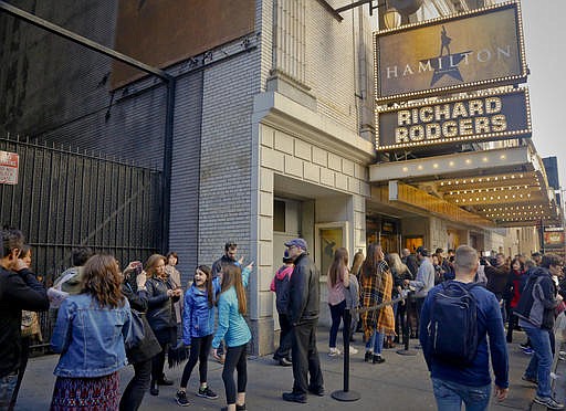 People line-up to see the Broadway play "Hamilton," Saturday Nov. 19, 2016, in New York. President-elect Donald Trump demanded an apology from the cast of the hit musical a day after an actor lectured Vice President-elect Mike Pence about equality, prompting angry responses from liberals and conservatives.