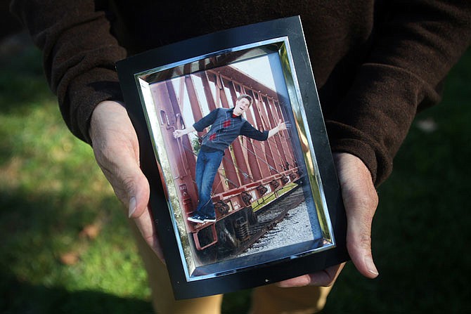 Jim Marshall holds a picture of his son, Cody Marshall, at the Capitol. Cody died of a drug overdose.