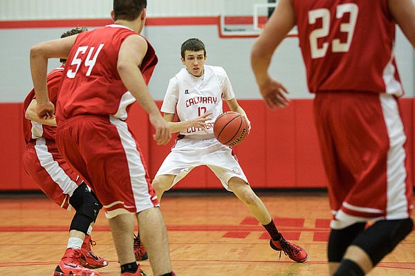 Colin Bernskoetter of Calvary Lutheran does a quick crossover in a game last season against Tuscumbia. Bernskoetter returns as the Lions' point guard this season.