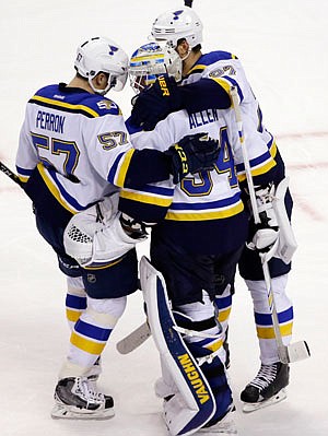 Blues left wing David Perron (57) and defenseman Alex Pietrangelo celebrate with goalie Jake Allen after their 4-2 victory against the Bruins on Tuesday night in Boston.