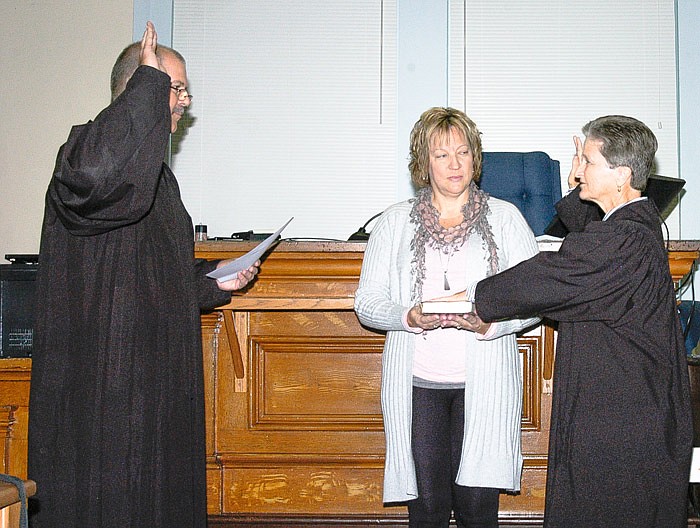 Circuit Judge Kenneth Michael Hayden, left, swears in the newest 26th Judicial Circuit Judge, Peggy D. Richardson, as Moniteau County Circuit Clerk Michele Higgins holds the Bible. The ceremony was held Friday, Nov. 18, in the courtroom of the Moniteau County Courthouse. Richardson joins Hayden and Judge G. Stanley Moore as the third judge of the 26th Judicial Circuit. The circuit covers Moniteau, Camden, Laclede, Miller and Morgan counties.