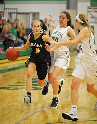 Lauren Alexander of Helias works her way down the court as Blair Oaks teammates Brooke Boessen (50) and Claire Heckman defend during Tuesday night's game in Wardsville.