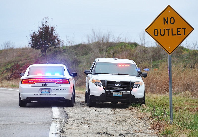 Cole County sheriff's deputies, parked on an outer road near Kaylor Bridge Road in St. Martins, meet Wednesday afternoon, Nov. 23, 2016 to discuss the search for suspect Jerry Dean Gill, who is wanted in the shooting of a woman on Monday.