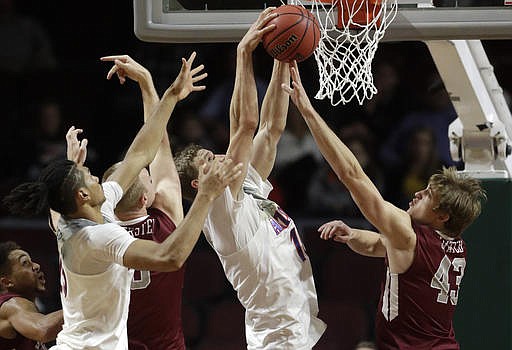 Santa Clara's Jarvis Pugh, left, watches as Arizona's Keanu Pinder, Santa Clara's Henrik Jadersten, Arizona's Lauri Markkanen and Santa Clara's Nate Kratch vie for a rebound during the second half of an NCAA college basketball game Thursday, Nov. 24, 2016, in Las Vegas. Arizona won 69-61.