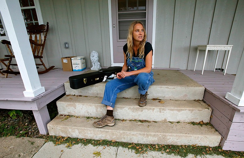 In this Oct. 3, 2016 photo, singer Lissie Maurus sits on her front porch at her Iowa farm. Maurus moved to Iowa from southern California after losing her record deal. She released an album "My Wild West,"this year has and a strong following in the UK, Norway and in her native Midwest. 