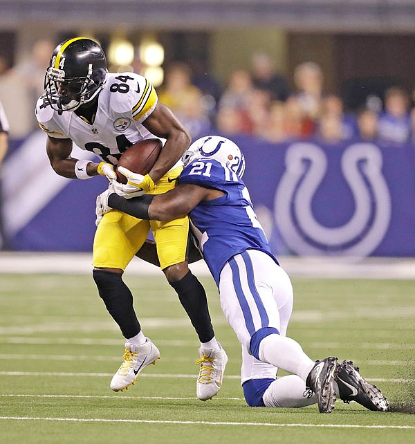 Steelers receiver Antonio Brown is tackled by Colts defensive back Vontae Davis during the first half of Thursday night's game in Indianapolis.