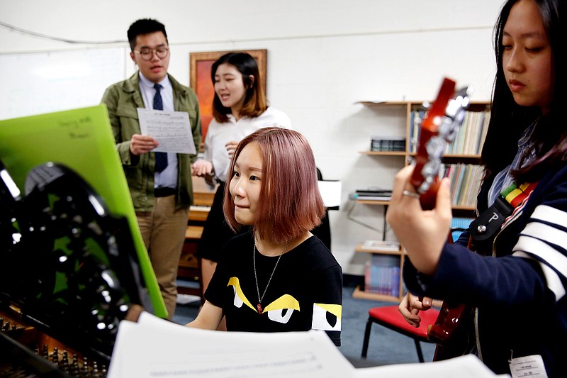 From left, Rain Liang, 18, a senior, Macy Wang, 16, a junior, Nicole Wang, 15, a sophomore, and Sherry Mai, 17, a junior, all of China, practice "Hey Jude" during music class on Oct. 18, 2016 at the Southwestern Academy, in San Marino, Calif. 