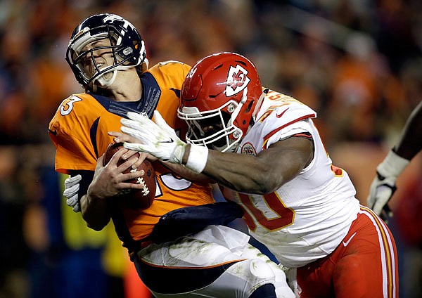 Chiefs outside linebacker Justin Houston sacks Broncos quarterback Trevor Siemian in the end zone for a safety during the first half of Sunday night's game in Denver.