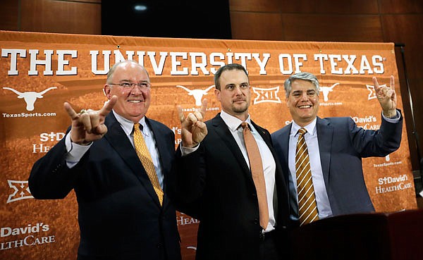 Tom Herman (center) poses with Texas athletic director Mike Perrin (left) and school president Gregory Fenves during Sunday's news conference in Austin, where he was introduced as the Longhorns' new head football coach.
