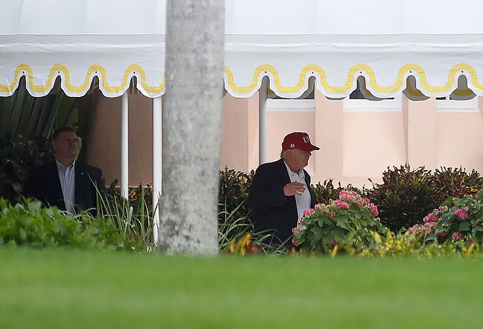 President-elect Donald Trump walks to his motorcade vehicle at Mar-A Lago, Sunday, as he heads back to New York.