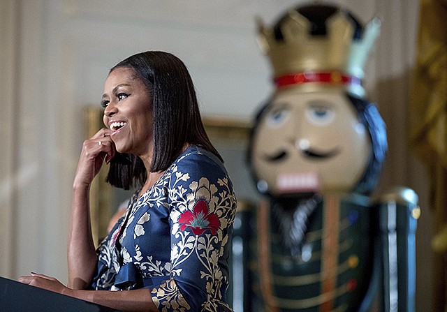 First lady Michelle Obama, pauses while speaking Tuesday to military families in the East Room of the White House during a preview of the 2016 holiday decor in Washington.