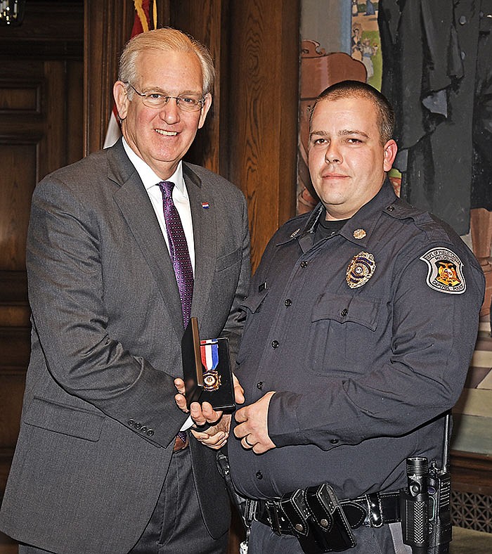 Gov. Jay Nixon presents to Medal of Valor to Capitol police officer Charles Gerhart.