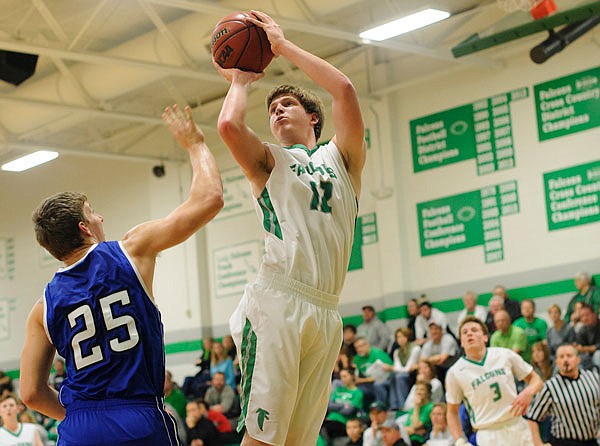 Jason Rackers of Blair Oaks puts up a jump shot over Mat Hug of Hermann during a game last season in Wardsville. Rackers is one of five seniors for the Falcons this season.