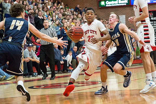 Jefferson City guard Kamari Balton drives to the hoop during a game against Helias last season at Fleming Fieldhouse. Balton is one of the Jays' top returning players.