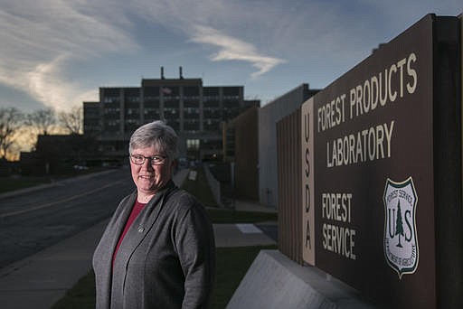 In a Tuesday, Nov. 21, 2016 photo, Melissa Baumann, a chemist at Forest Products Lab, stands in outside of the facility in Madison, Wis. Baumann is one of the nation's 4 million or so federal workers who is watching anxiously as President-elect Donald Trump looks to set his agenda on federal employees in motion.