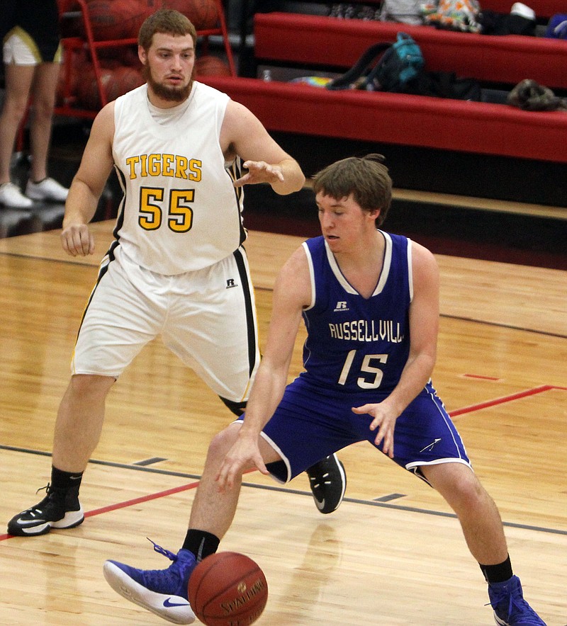 Russellville's David Sheldon looks to drive on Smithton's Evan Breheim in Tuesday's game at the Tipton Tournament.