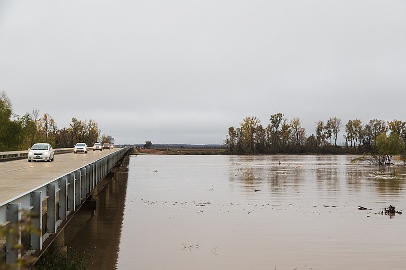 In this file photo, the Red River is flooded Saturday, Nov. 28, 2015, north of DeKalb, Texas.