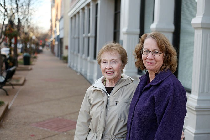 Laura Cartmill-Cooley, left, and Nanette Nacy pose for a portrait downtown. They will be serving as grand marshals in Saturday's Jaycees Christmas Parade.