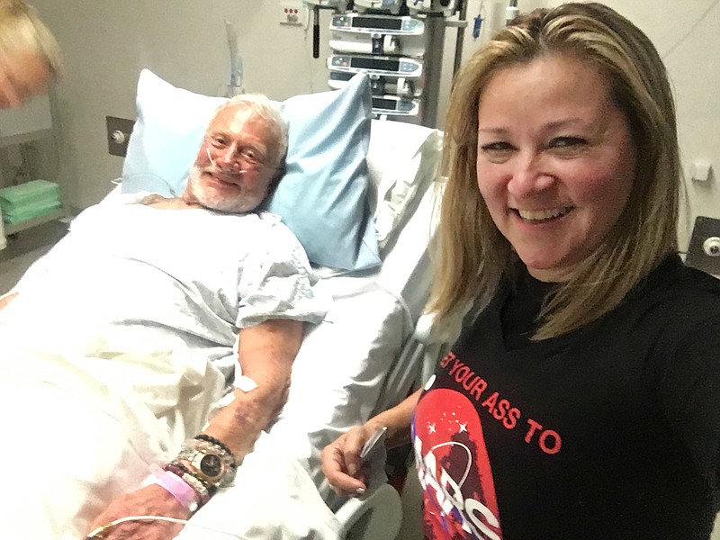 In this Friday, Dec. 2, 2016, photo provided by Christina Korp, right, Buzz Aldrin lies in a hospital bed in Christchurch, New Zealand. Aldrin, the second man to walk on the moon, was evacuated from the South Pole to New Zealand where he was hospitalized in stable condition.