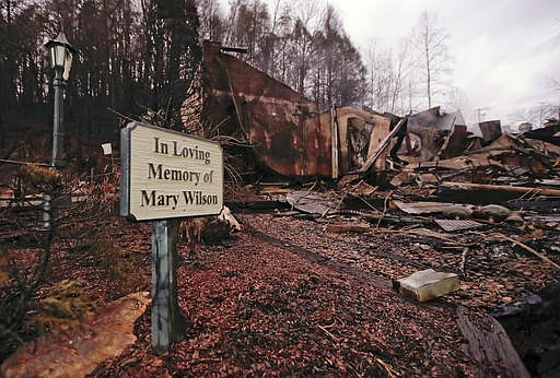 Smoke rises from the remains of the Alamo Steak House Wednesday, Nov. 30, 2016, in Gatlinburg, Tenn., after a wildfire swept through the area Monday.