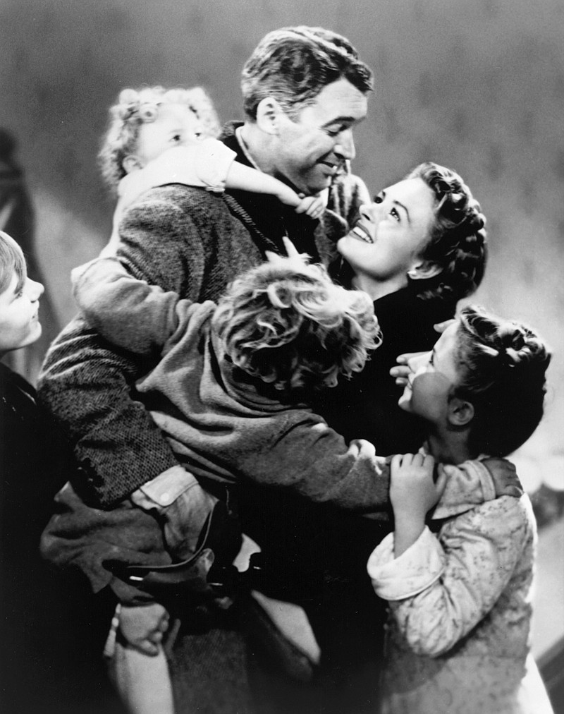 This image released by NBC shows James Stewart, center, and Donna Reed, background in a scene from Frank Capra's 1946 holiday classic, "It's A Wonderful Life," airing Dec. 3 and Dec. 24, on NBC.  