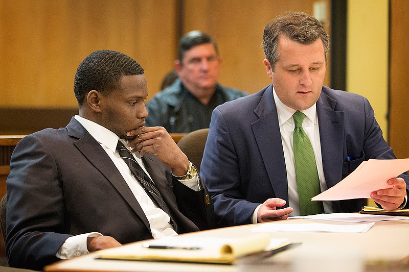 Clifford Gayton Jr. and his attorney Josh Potter go over court documents following Gayton being found guilty of capital murder and and third-degree injury to a child Friday. On the jury's recommendation, Gayton, 19, received the maximum sentence on both charges. 
