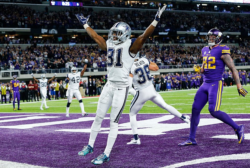 Dallas Cowboys free safety Byron Jones (31) celebrates in front of Minnesota Vikings tight end Kyle Rudolph, right, after breaking up a pass in the end zone during the second half of an NFL football game Thursday, Dec. 1, 2016, in Minneapolis. The Cowboys won 17-15.