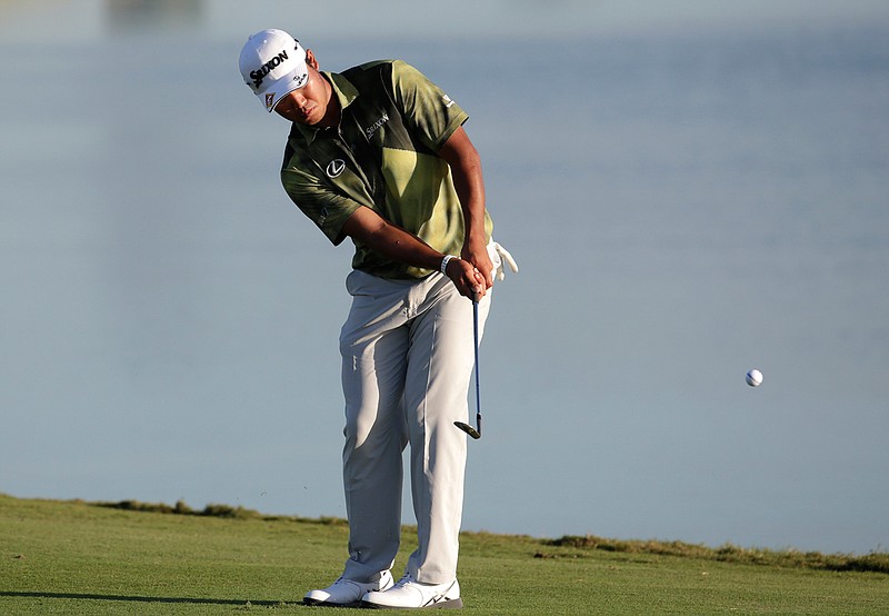 Hideki Matsuyama, of Japan, chips onto the 18th green during the second round at the Hero World Challenge golf tournament, Friday, Dec. 2, 2016, in Nassau, Bahamas. 