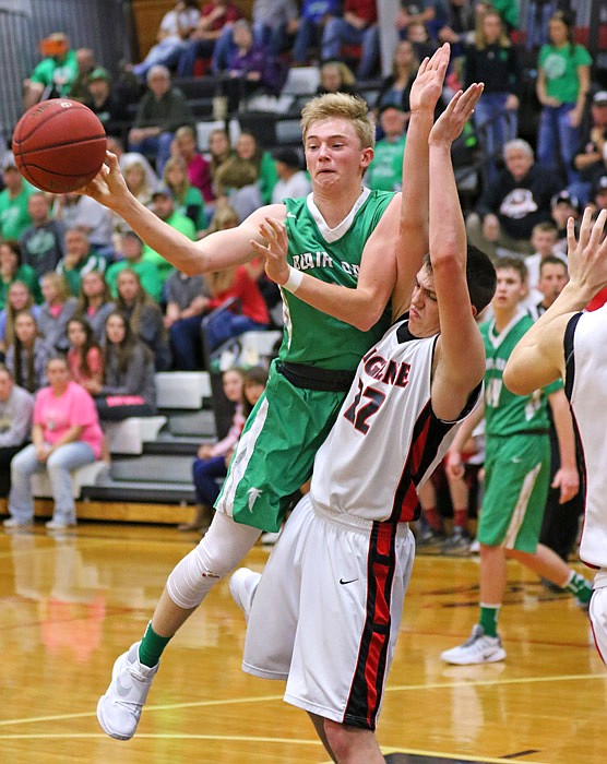 Thomas Verslues of Blair Oaks passes the ball toward the perimeter as Jarret Magers of Eugene defends on Saturday, Dec. 3, 2016 during their Eugene Tournament title game.