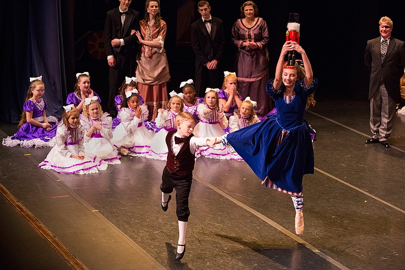  Clara, played by Chloe Carpenter, holds her new nutcracker Sunday as she dances with her little brother, played by Seth Small, in "The Nutcracker" at the Perot Theatre. The ballet is based on a German Christmas story by E.T.A. Hoffmann. 