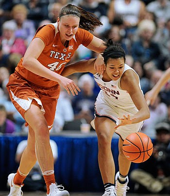 Napheesa Collier of Connecticut steals the ball from Kelsey Lang of Texas during the second half of Sunday's game in Uncasville, Conn.