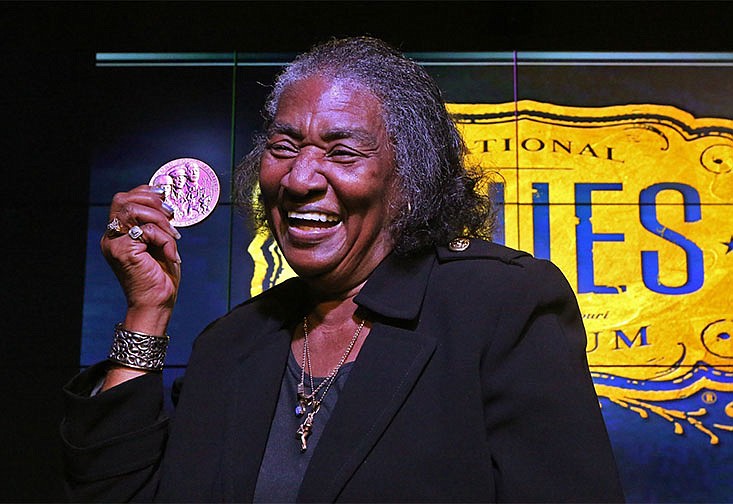 Frances Johnson, widow of jazz and blues pianist Johnnie Johnson, holds up the Congressional Gold Medal that was awarded to her late husband during a ceremony at the National Blues Museum in downtown St. Louis. Johnnie Johnson died in St. Louis in 2005.
