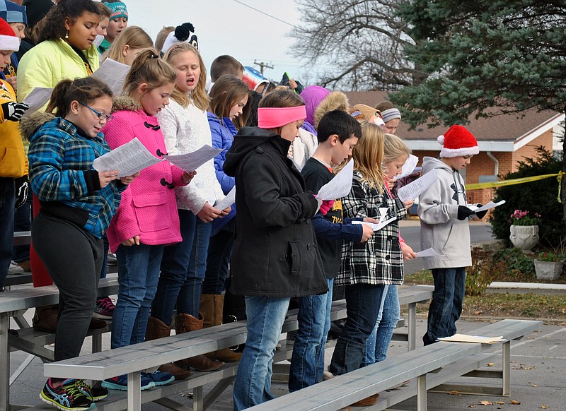 The Morgan County R-2 School District's children's choir perform "We Wish You a Merry Christmas" during Christmas on the Square Saturday in Versailles.