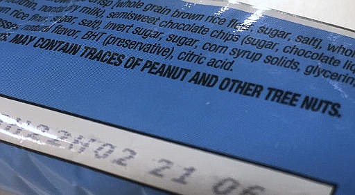 This Nov. 30, 2016, photo shows part of a food label that states the product "may contain traces of peanut and other tree nuts" as photographed in Washington. A new report says the hodgepodge of warnings that a food might accidentally contain a troublesome ingredient is confusing to people with food allergies, and calls for a makeover. The report from the prestigious National Academies of Sciences, Engineering and Medicine said it's time for regulators and the food industry to clear consumer confusion with labels that better reflect the level of risk. 