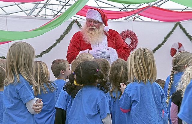 Santa Claus talks to the YMCA Child Development Center group of pre-kindergarden children Tuesday during the Parks, Recreation and Forestry Department's Candy Cane Hunt. Santa Claus answered the children's questions about his workshop and the North Pole.